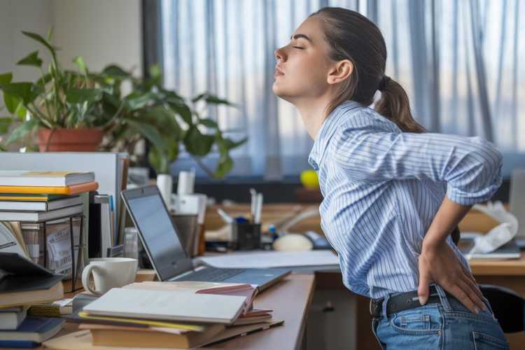 a lady at office with back pain